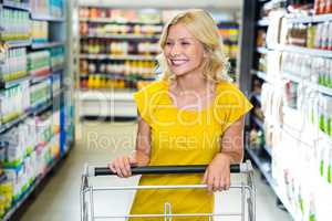 Smiling woman pushing cart