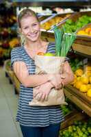 Smiling woman holding grocery bag