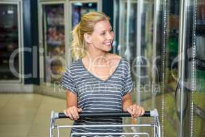Smiling woman pushing cart