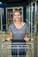 Portrait of smiling woman pushing cart