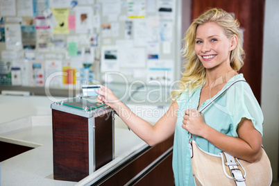 Smiling woman paying with credit card