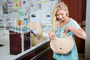 Smiling woman opening bag