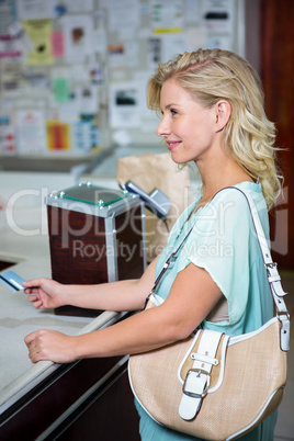Smiling woman paying with credit card Smiling woman paying with credit card