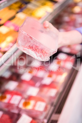 Smiling woman taking meal in the aisle