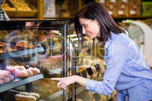 Pretty smiling woman choosing her dessert