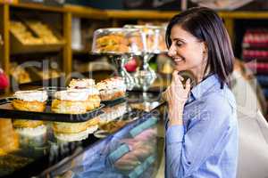 Pretty smiling woman choosing her dessert