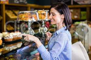 Pretty smiling woman choosing her dessert