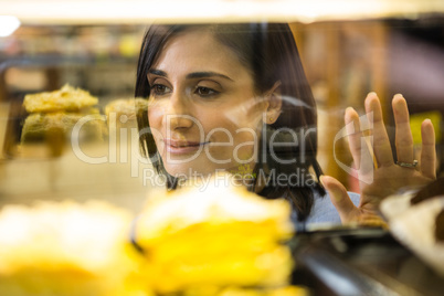 Pretty smiling woman choosing her dessert