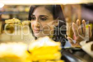 Pretty smiling woman choosing her dessert