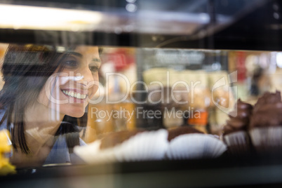 Pretty smiling woman choosing her dessert