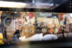 Pretty smiling woman choosing her dessert