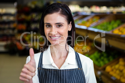 Smiling young worker with thumbs up