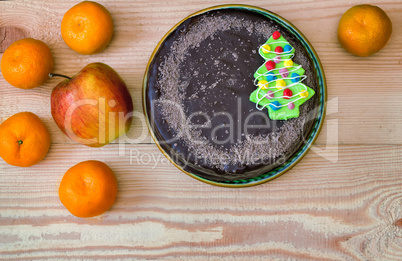Chocolate cake and fruit: apples and tangerines.