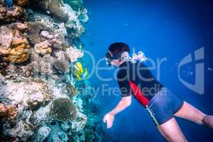 Snorkeler Maldives Indian Ocean coral reef.