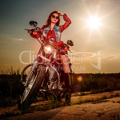 Biker girl sitting on motorcycle