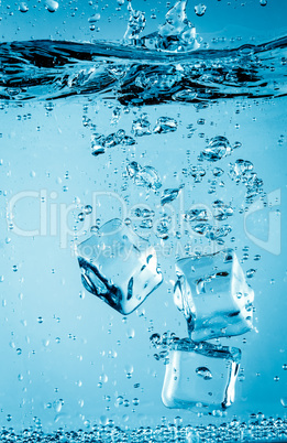 Ice cubes falling under water