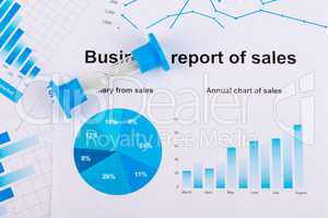 Financial charts and graphs. Sales report on paper. Hourglass. The countdown profits