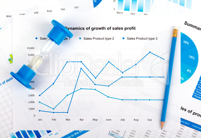 Financial chart with hourglass and blue pencil