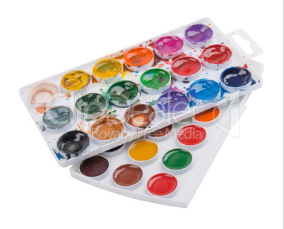 New and used watercolor paints in palette isolated on white background