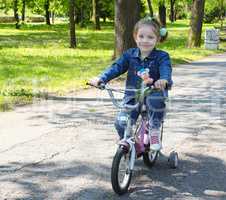 child riding bicycle in park