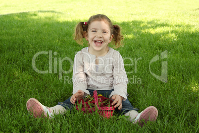 happy young girl sitting on grass in park