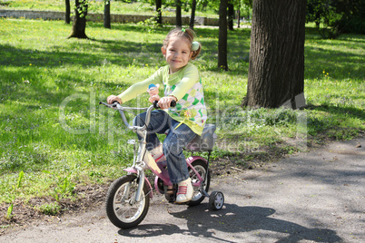 young girl riding bicycle in park