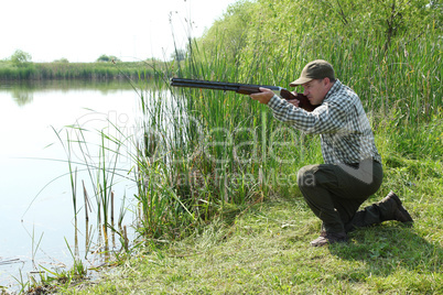 hunter aiming and ready for shot wild duck hunting