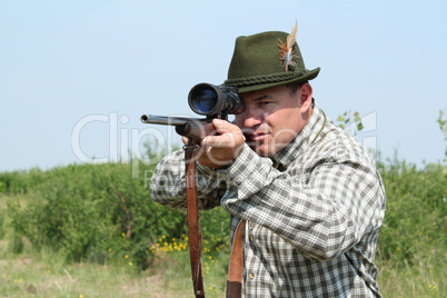 hunter with rifle ready for shot