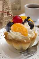 Cake in the form of a basket with cream and cherries