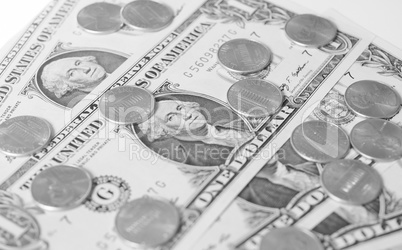 Black and white Dollar coins and notes