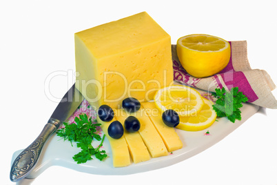 Big piece of cheese, lemon and olives on a white background.