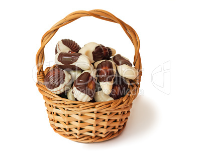 Chocolates in a wattled basket on a white background.