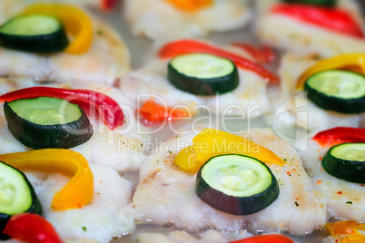 Fillet of fish roasted and decorated with vegetables.