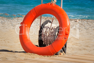 Lifebuoy at water on the coast of a sea beach.
