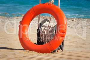 Lifebuoy at water on the coast of a sea beach.