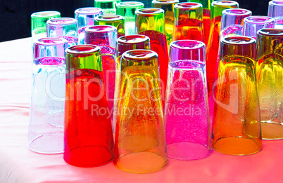 Beautiful colored glasses on the table surface.