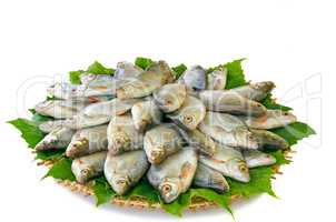 River fish (carp) and the greens on a round dish.