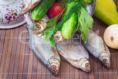 Fish and components for her preparation: vegetables, spices, par