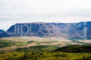 Large mountain plateau and valley under cloudy sky