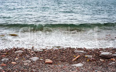 Pebble and stone beach with incoming wave