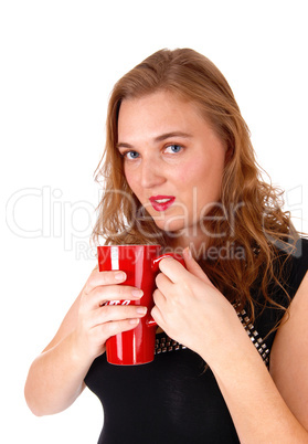 Blond woman drinking coffee.