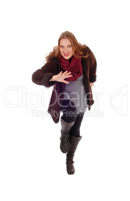 Dancing woman in winter coat.