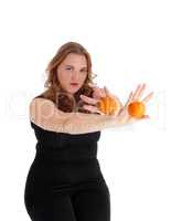 Woman holding two oranges.