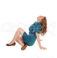 Woman in dress sitting on floor.