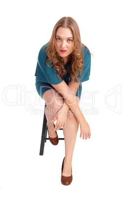 Woman sitting on chair bend forwards.