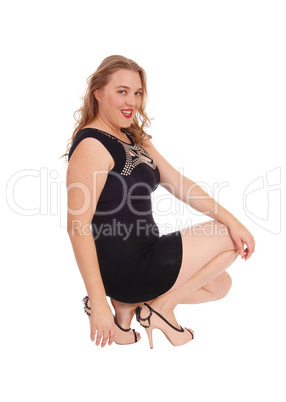 Smiling woman crouching on floor.