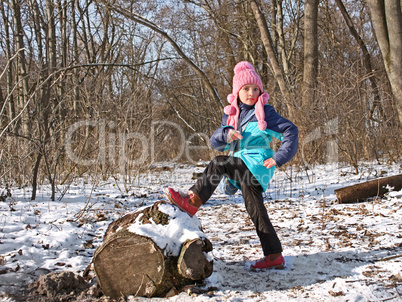 Little girl in the forest in wintertime