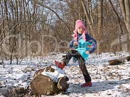 Little girl in the forest in wintertime