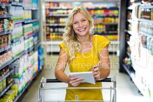 Blonde smiling woman checking list