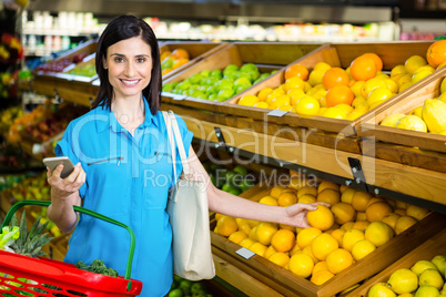 Portrait of a smiling woman picking orange